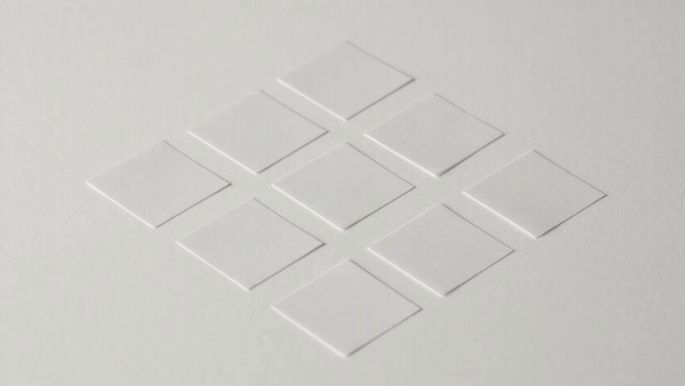 A gif of nine pieces of paper paper being folded seemingly on their own