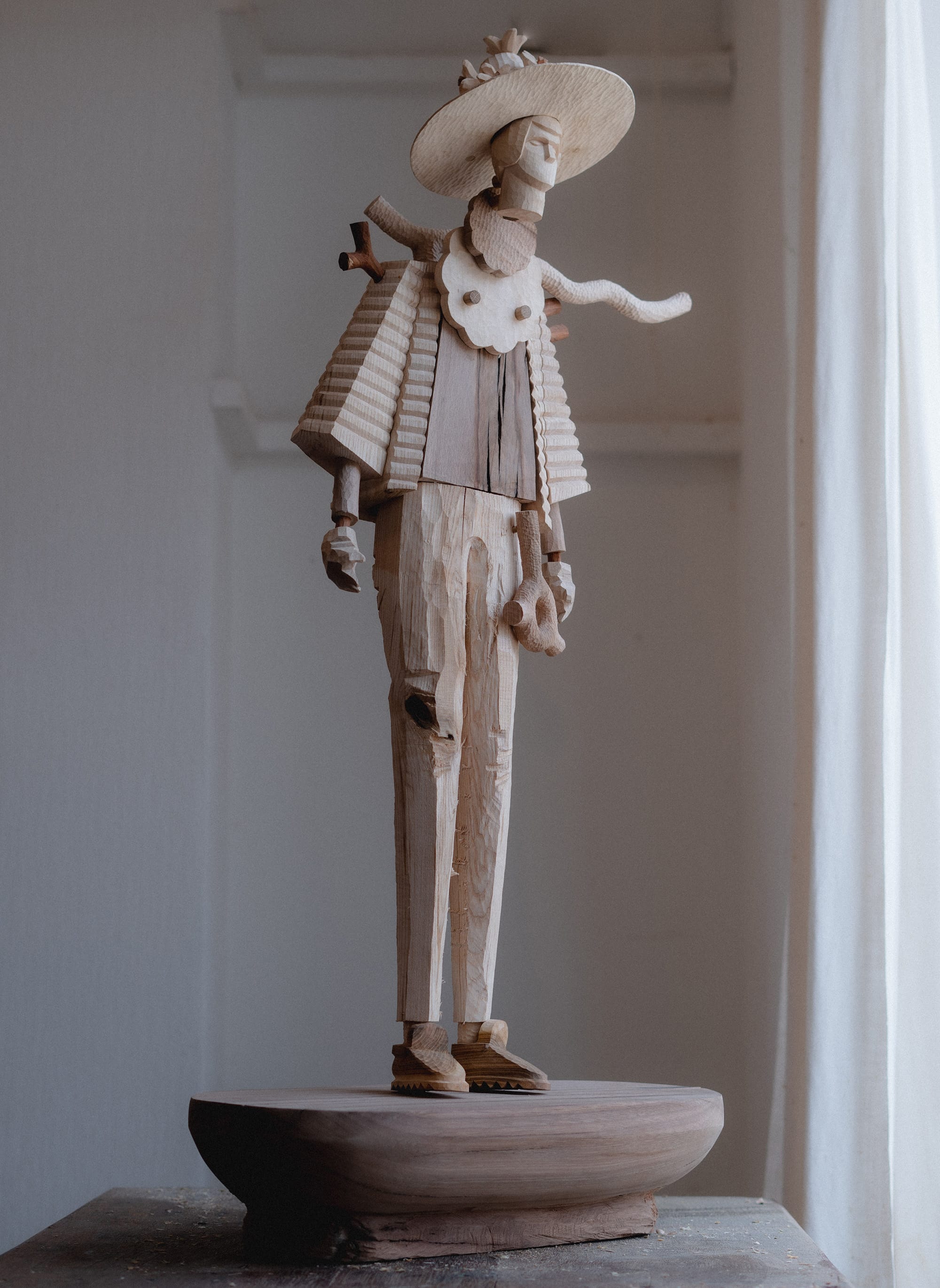 a wooden figure with adventurous clothing by Henry Wood