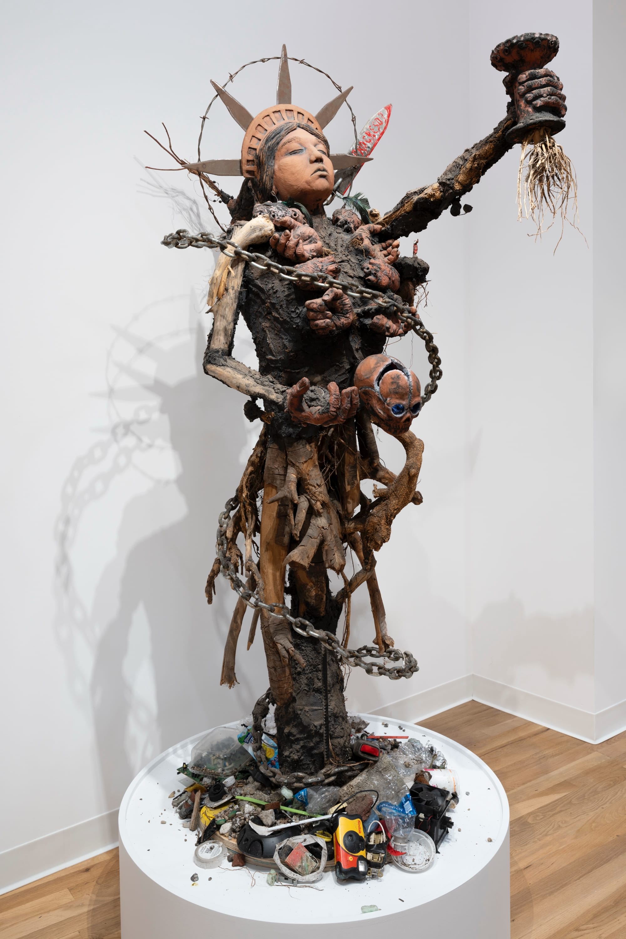 a figurative assemblage referencing the statue of liberty made of found objects