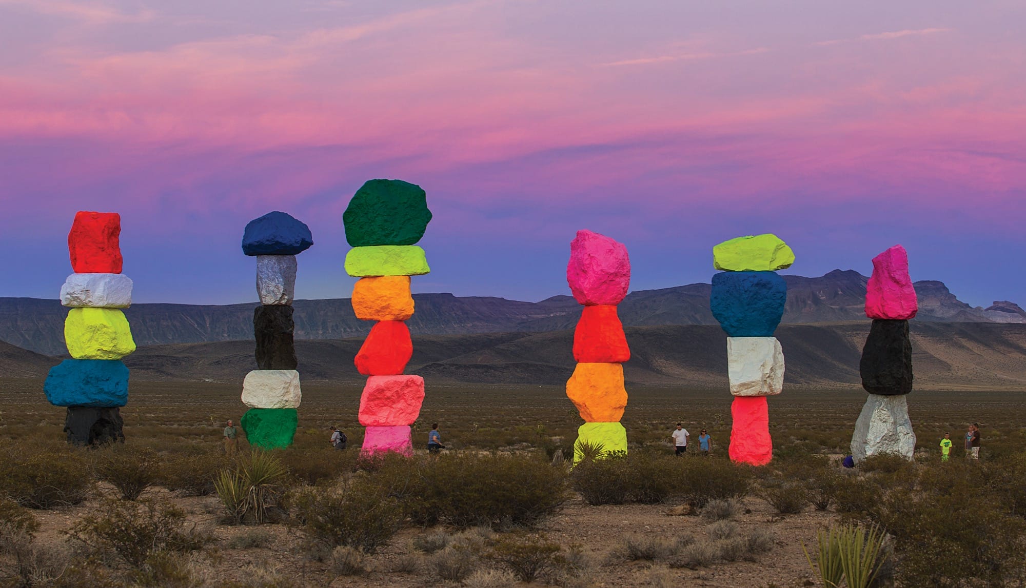 a collection of colorful stone totems by ugo rondinone