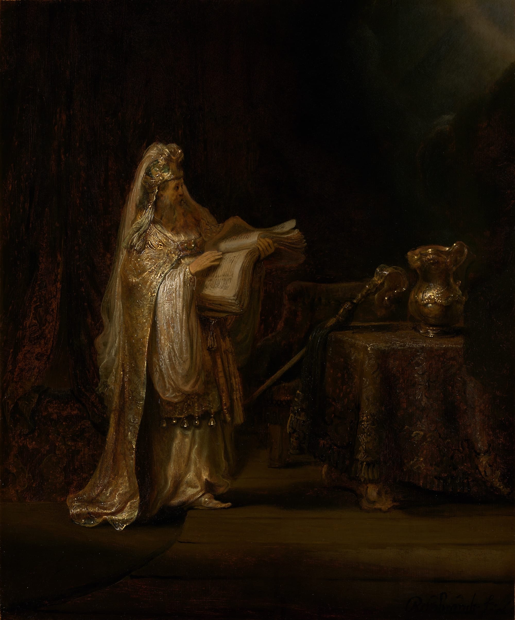 A 17th-century oil painting by Rembrandt of a priest looking at a large book in a temple