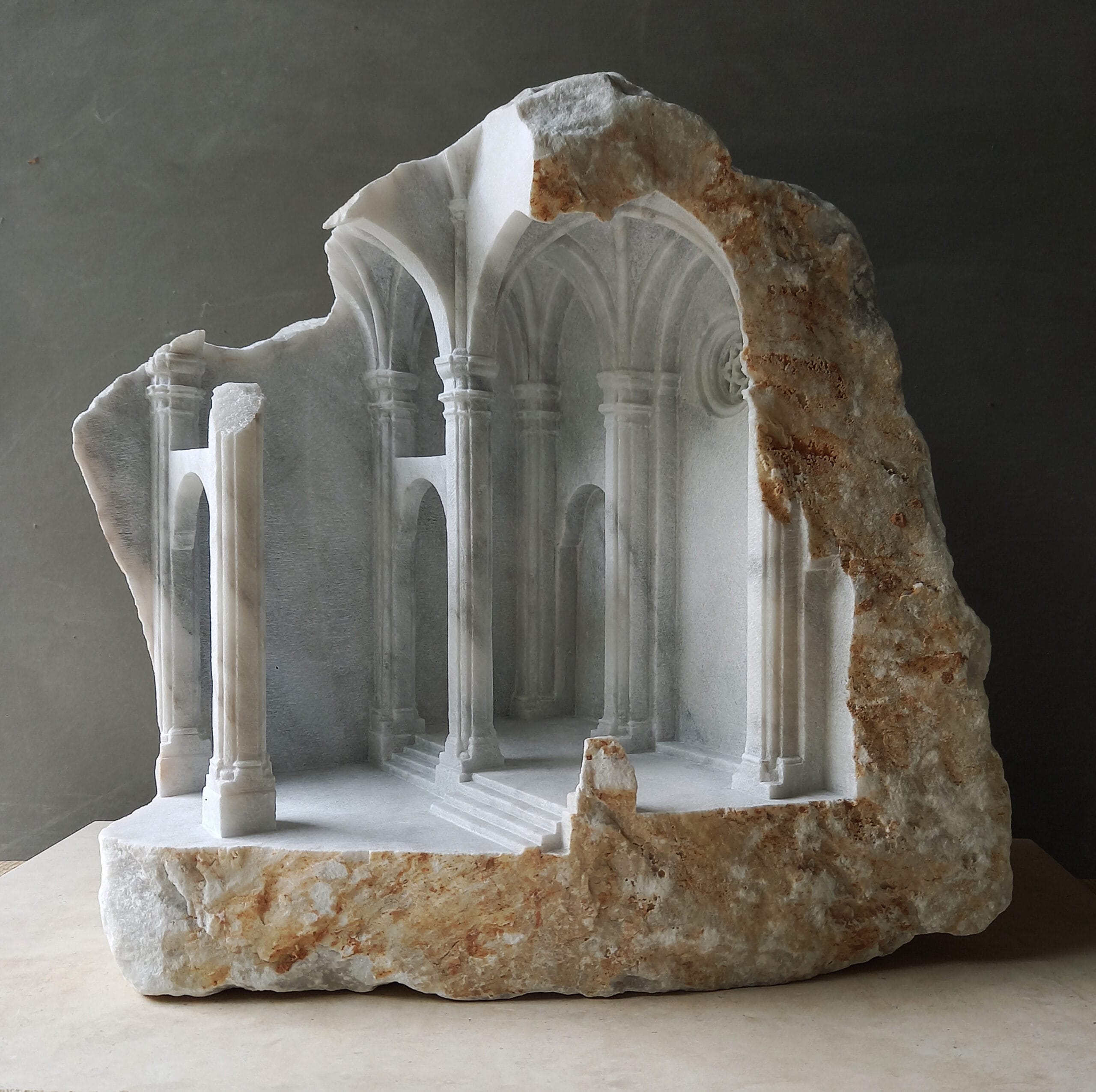 Architectural columns and arches meticulously carved in miniature in a hunk of marble